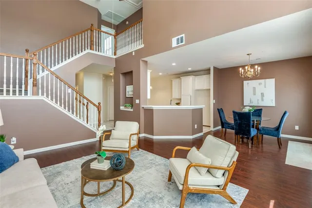a living room with furniture and a dining table with kitchen view