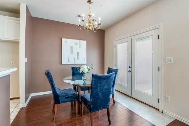 a view of a dining room with furniture and chandelier