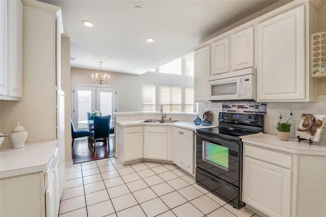 a kitchen with a sink cabinets and window