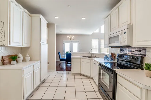 a kitchen with a sink stove and cabinets