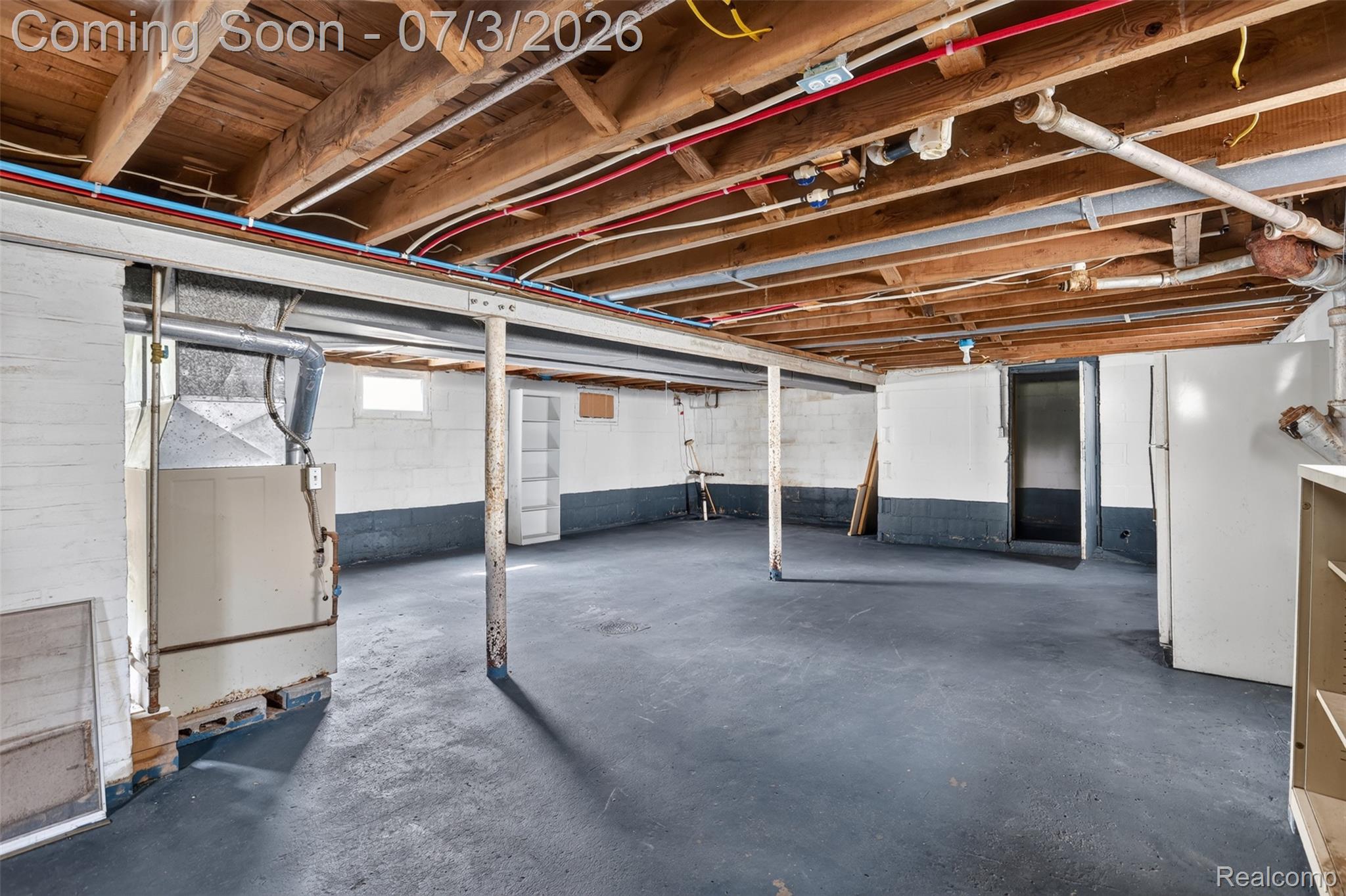 4322 Baker Road Bridgeport, MI 48722 - Photo 20 of 29 Expansive unfinished basement featuring exposed ceiling joists, painted concrete block walls, and a durable concrete floor