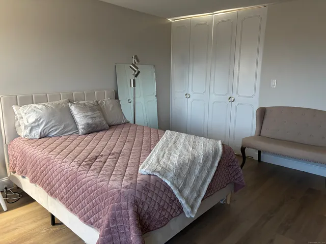 a bedroom with a bed and a couch