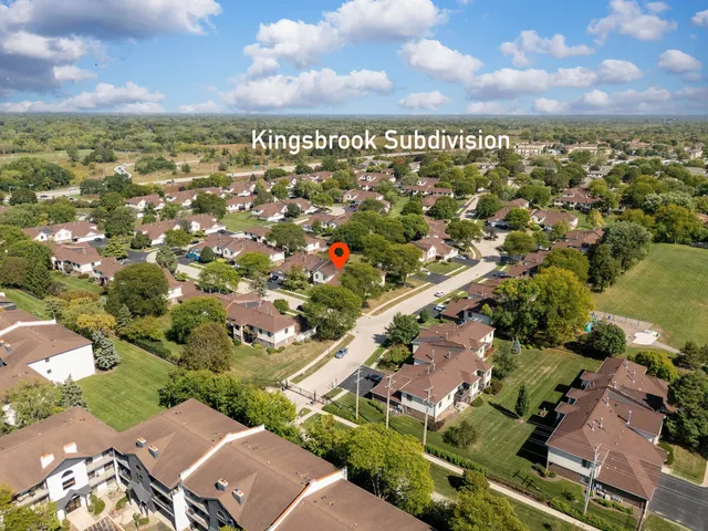 an aerial view of a residential houses with city view