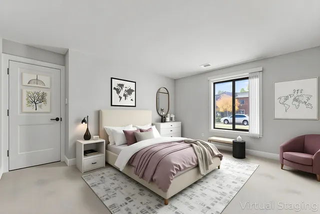 a bedroom with a large bed couch and a window