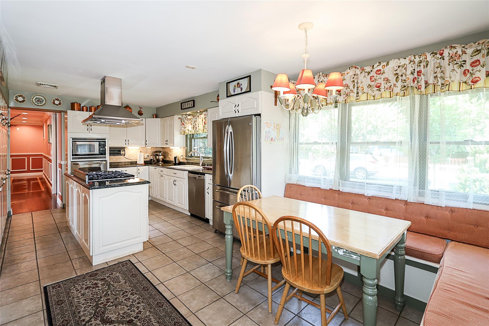 19 Marietta Road Glen Cove, NY 11542 - Photo 12 of 46 a kitchen with granite countertop a dining table chairs stainless steel appliances and cabinets