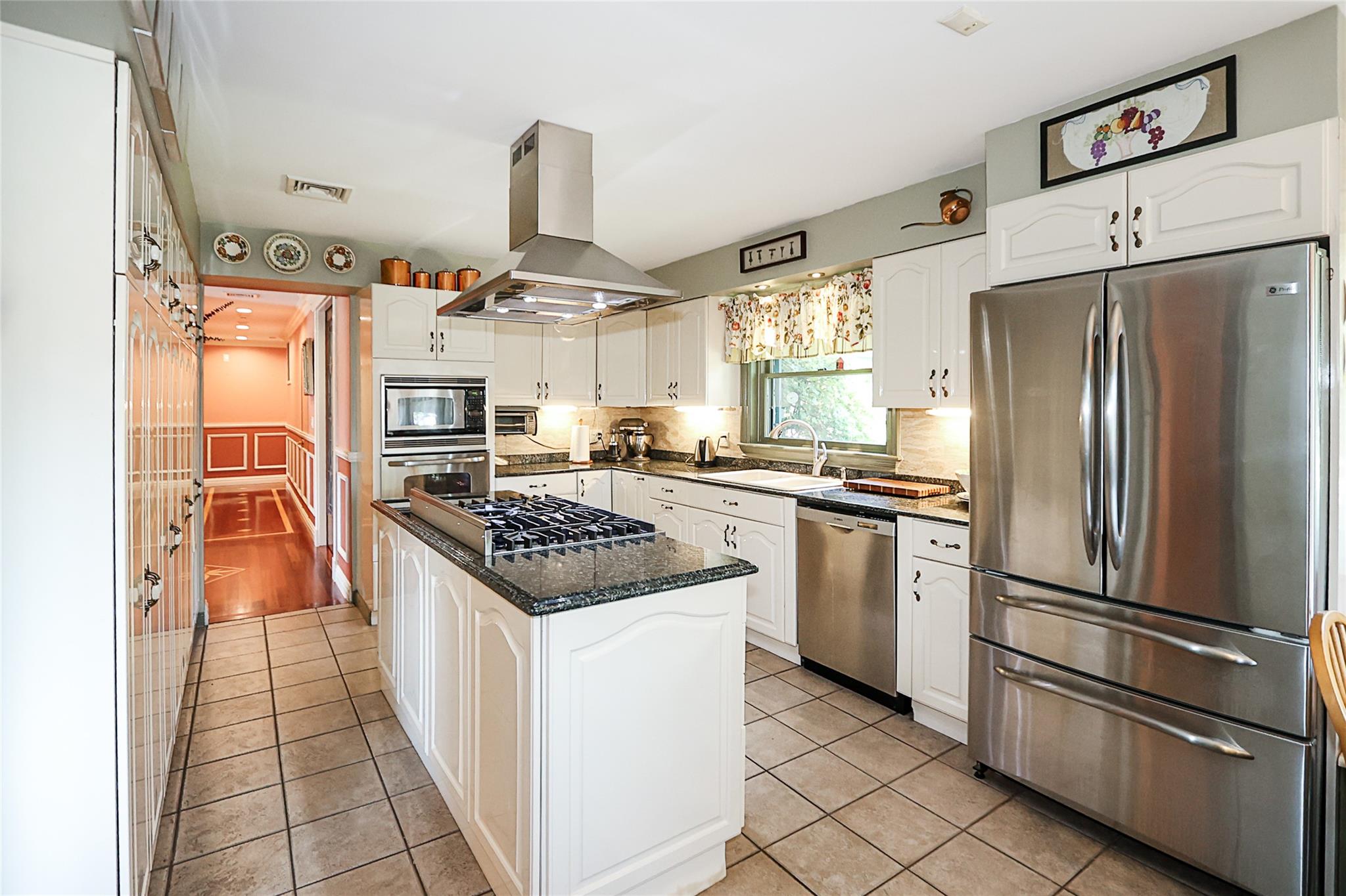 19 Marietta Road Glen Cove, NY 11542 - Photo 13 of 46 a kitchen with stainless steel appliances granite countertop a refrigerator a stove and a sink
