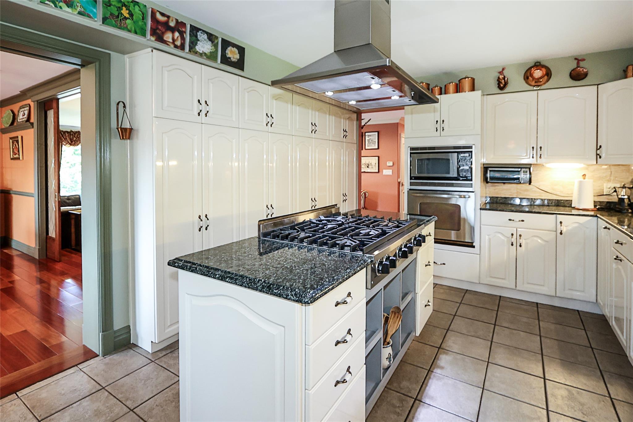 19 Marietta Road Glen Cove, NY 11542 - Photo 15 of 46 a kitchen with a stove a sink and a refrigerator