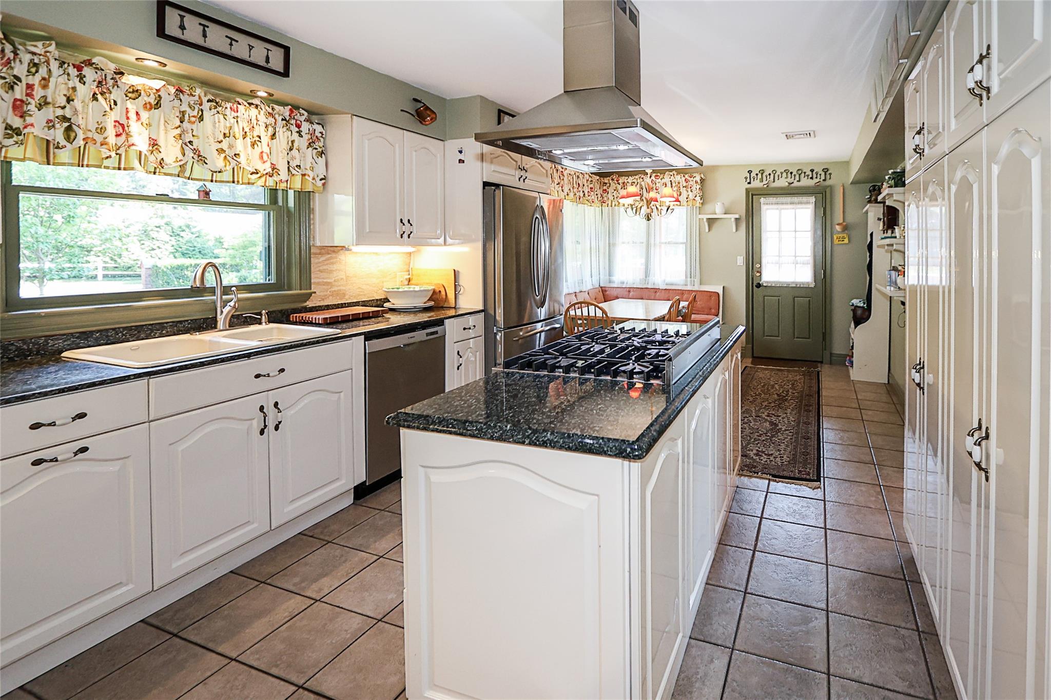 19 Marietta Road Glen Cove, NY 11542 - Photo 17 of 46 a kitchen with stainless steel appliances granite countertop a stove a sink and a refrigerator