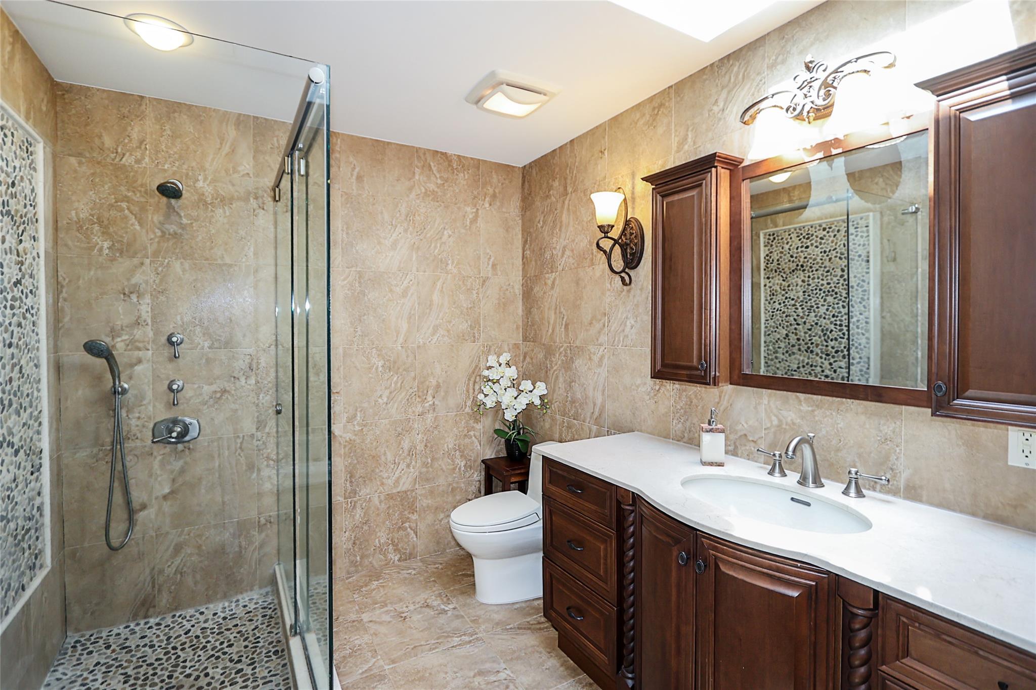 19 Marietta Road Glen Cove, NY 11542 - Photo 20 of 46 a bathroom with a double vanity sink mirror and shower