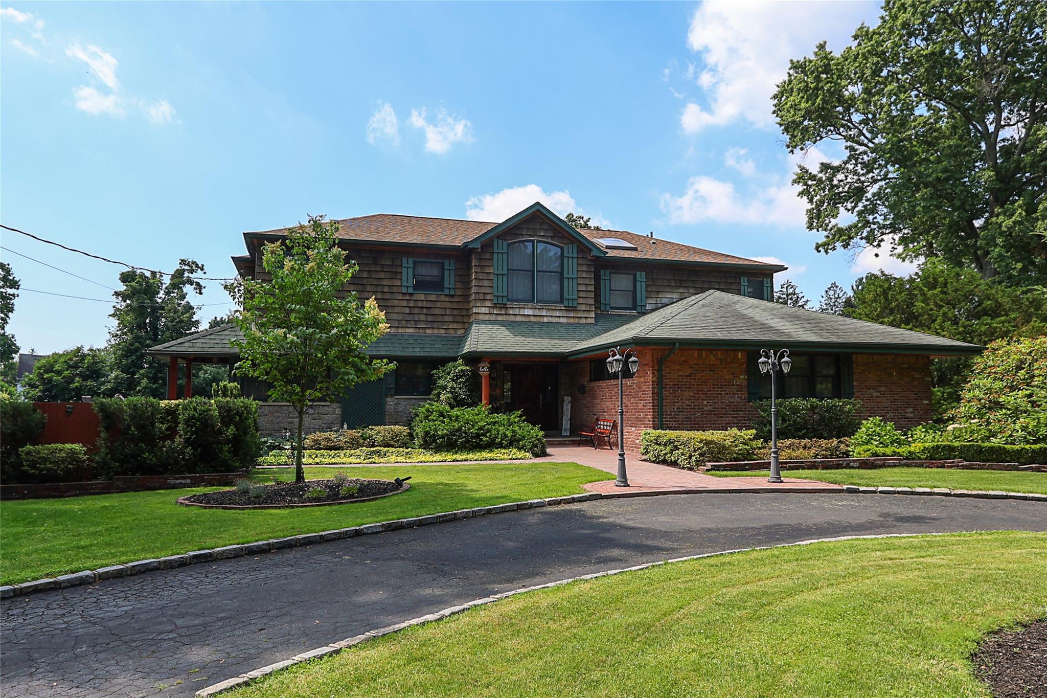 19 Marietta Road Glen Cove, NY 11542 - Photo 2 of 46 a front view of a house with a yard