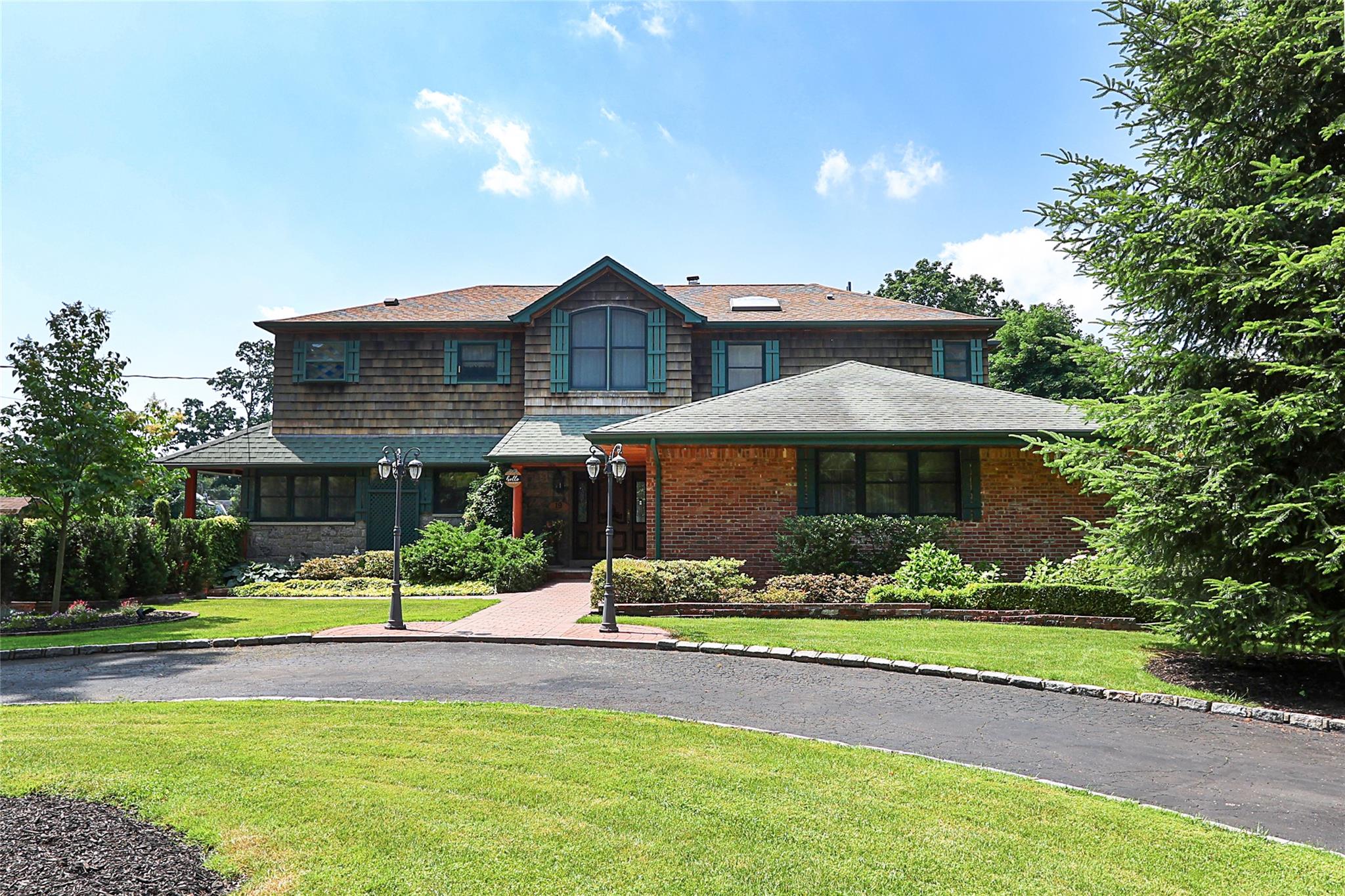 19 Marietta Road Glen Cove, NY 11542 - Photo 3 of 46 a front view of a house with yard and green space
