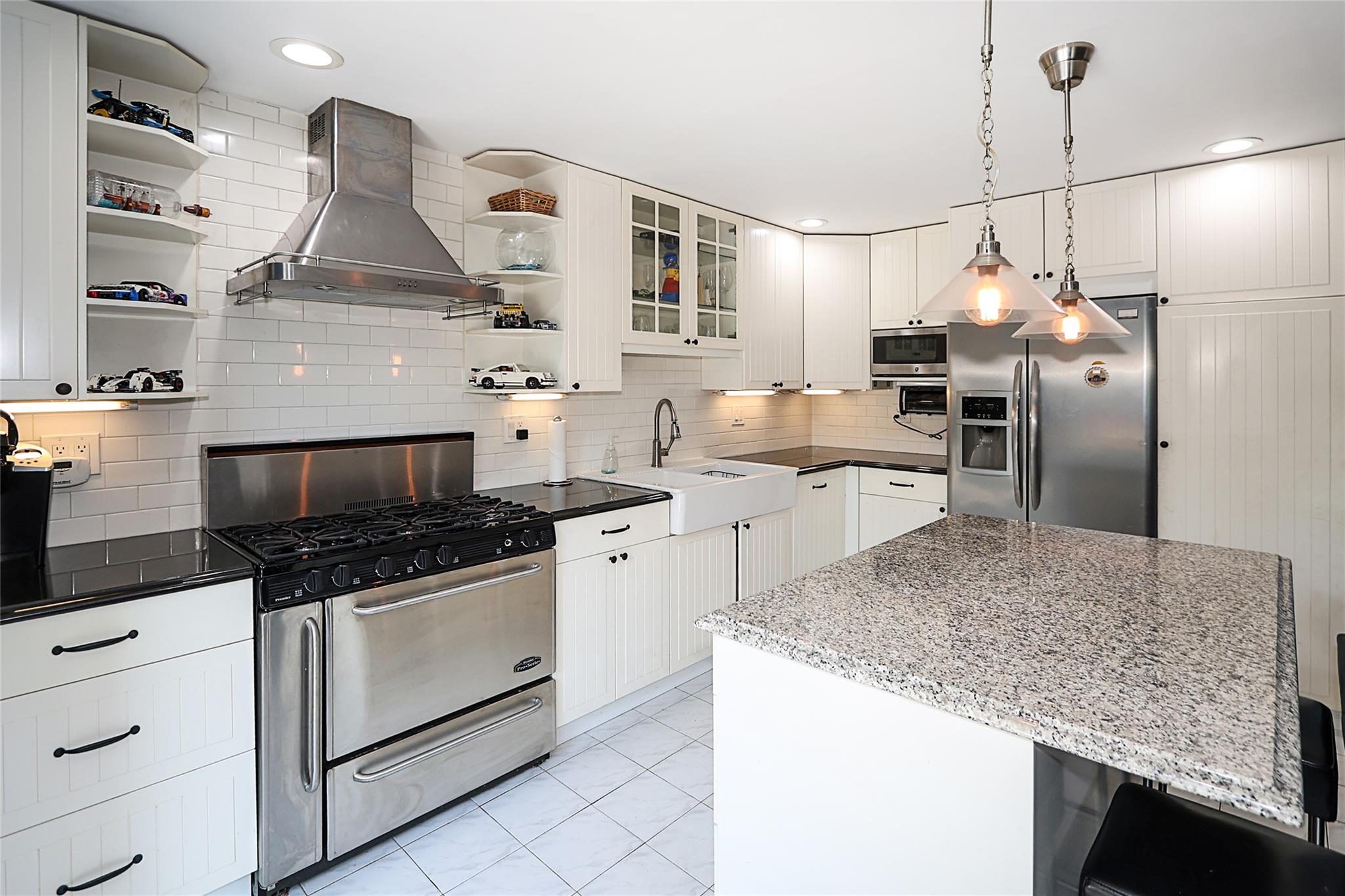 19 Marietta Road Glen Cove, NY 11542 - Photo 40 of 46 a kitchen with granite countertop a sink stainless steel appliances and cabinets
