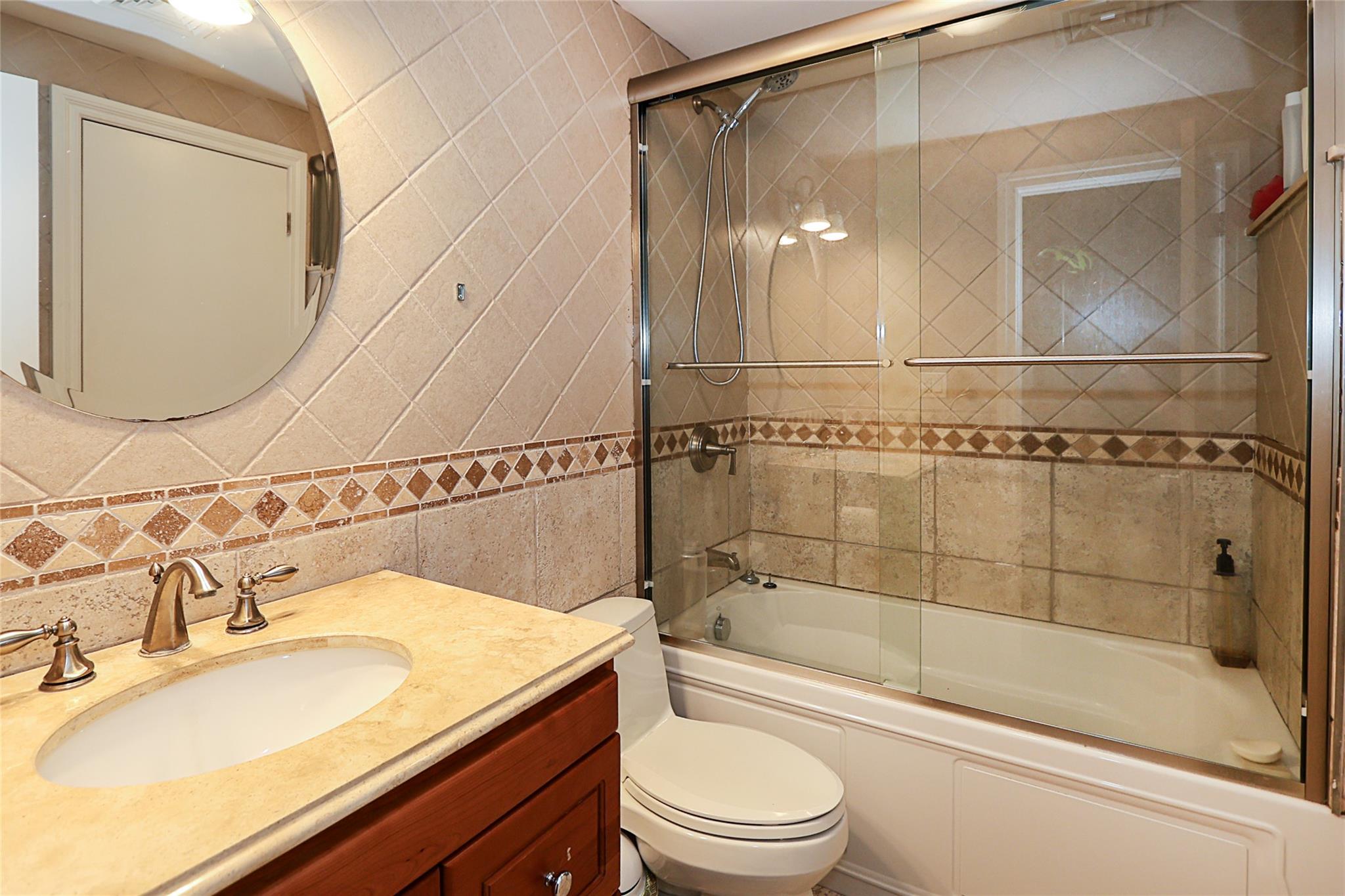 19 Marietta Road Glen Cove, NY 11542 - Photo 42 of 46 a bathroom with a sink a toilet and shower