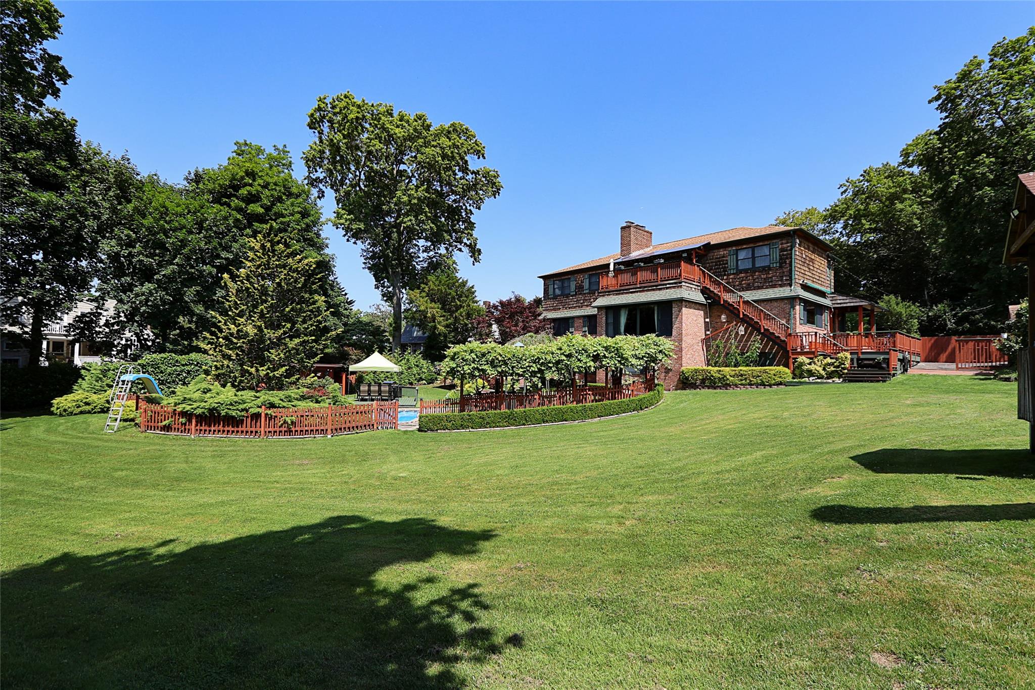 19 Marietta Road Glen Cove, NY 11542 - Photo 45 of 46 a view of a house with a big yard and potted plants