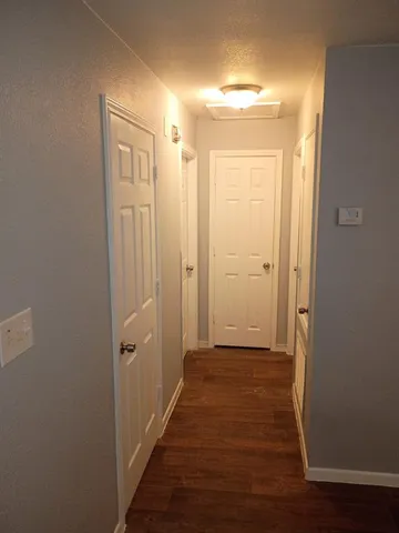 a view of a hallway with wooden floor