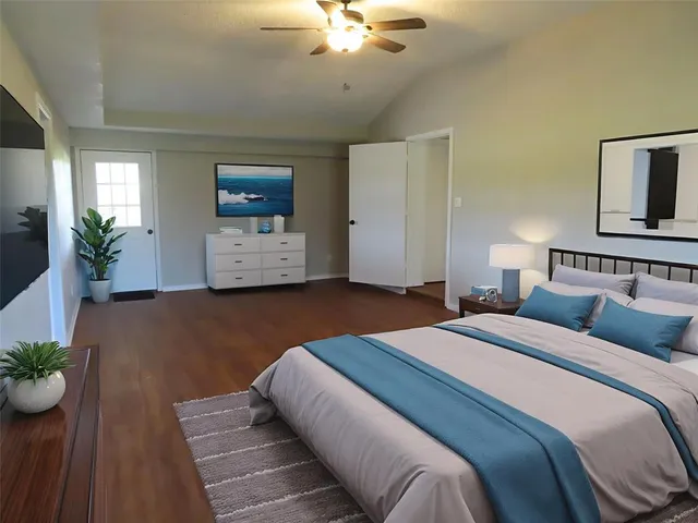 a bedroom with bed and a chandelier