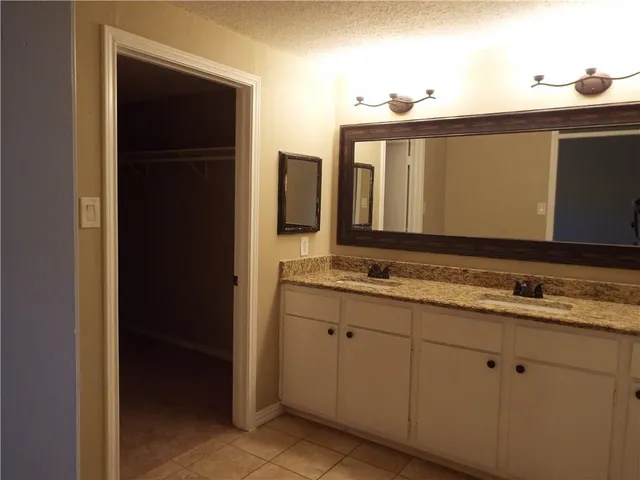 a bathroom with a sink and mirror