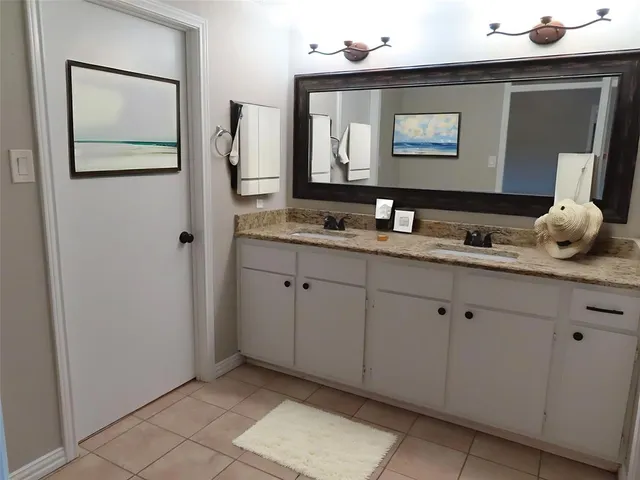 a bathroom with a double vanity sink and a mirror