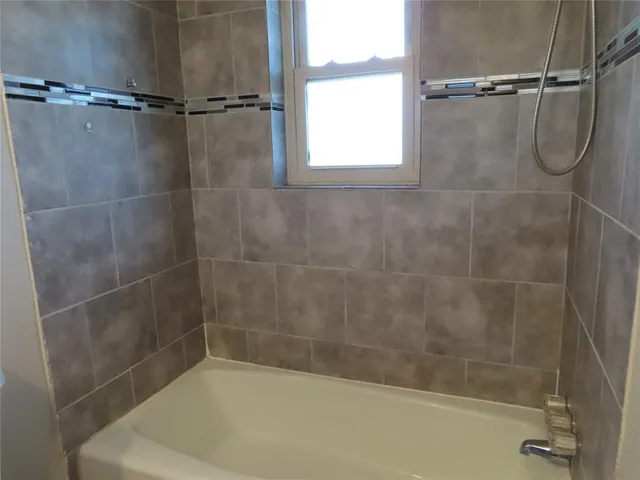 a bathroom with a shower and a bathtub