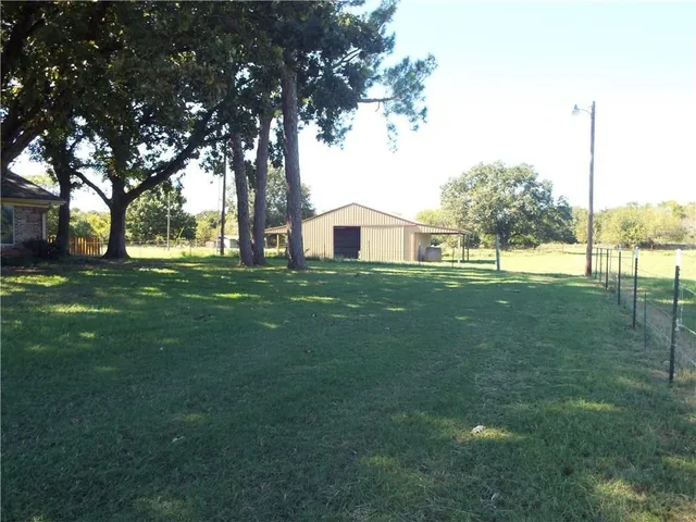 a view of a house with a big yard