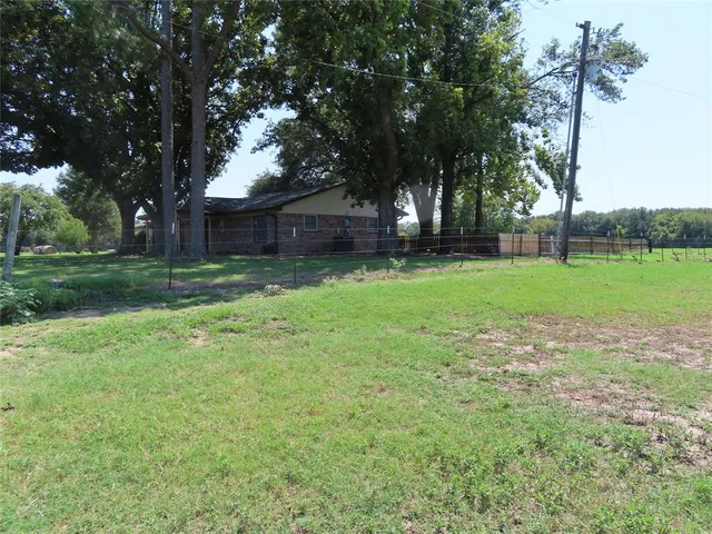 a view of a backyard with large trees