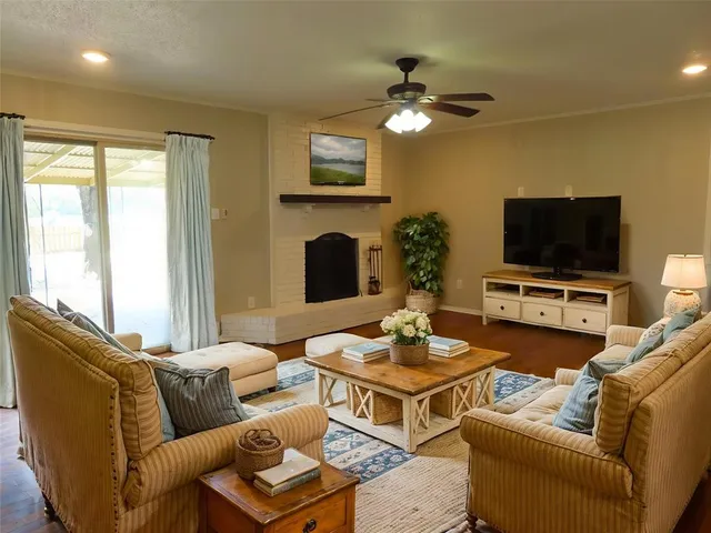 a living room with furniture a fireplace and a flat screen tv