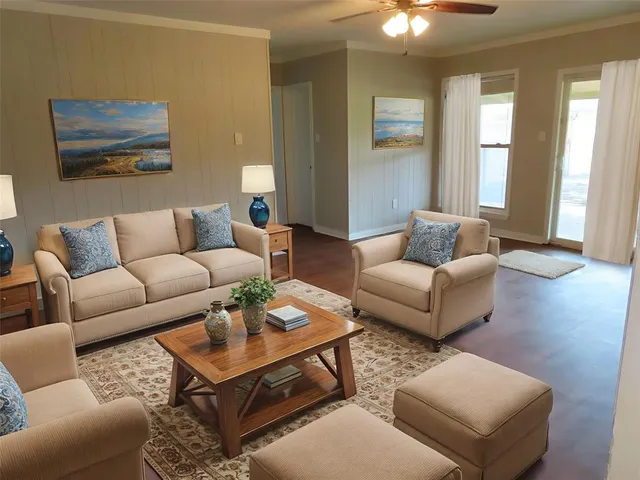 a living room with furniture a rug and a window