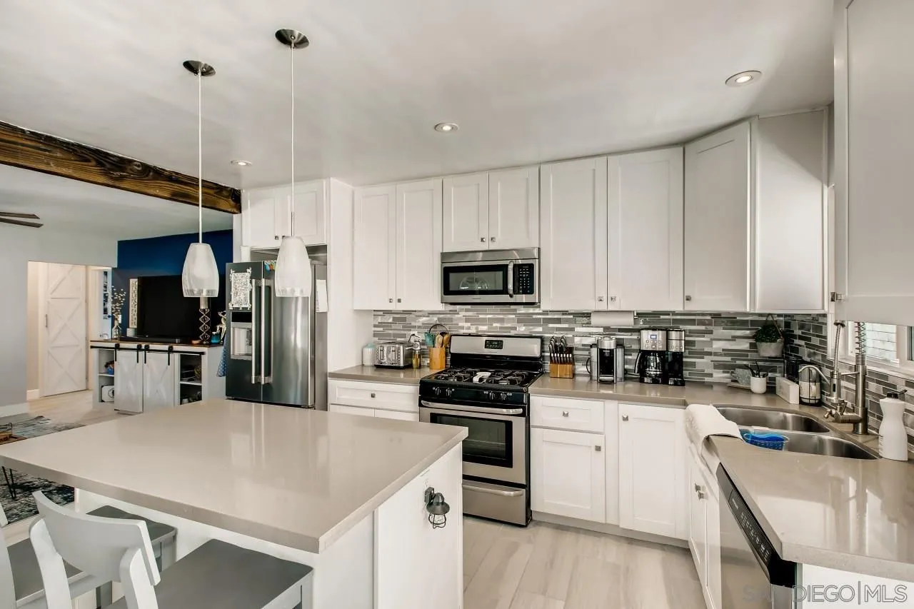 452 Concepcion Avenue Spring Valley, CA 91977 - Photo 8 of 25 a kitchen with a sink a stove a refrigerator and cabinets