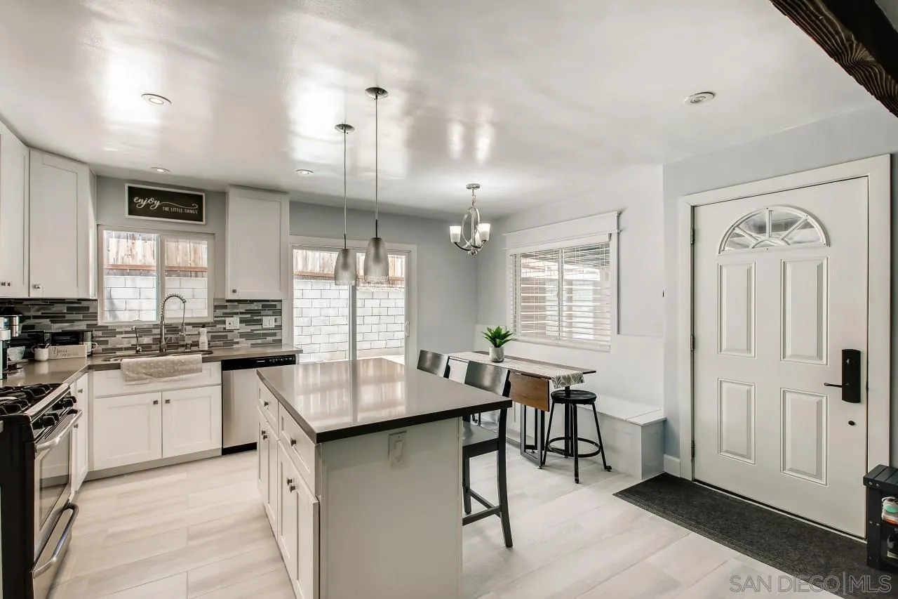 452 Concepcion Avenue Spring Valley, CA 91977 - Photo 10 of 25 a kitchen with center island table and chairs in it