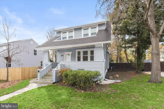 a front view of a house with a yard and outdoor seating