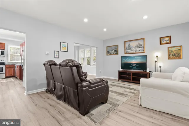 a living room with furniture a flat screen tv and a couch