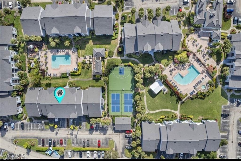 13571 Eagle Ridge Drive, Unit 1325 Fort Myers, FL 33912 - Photo 2 of 17 Aerial view of property and surrounding area featuring a pool and nearby suburban area