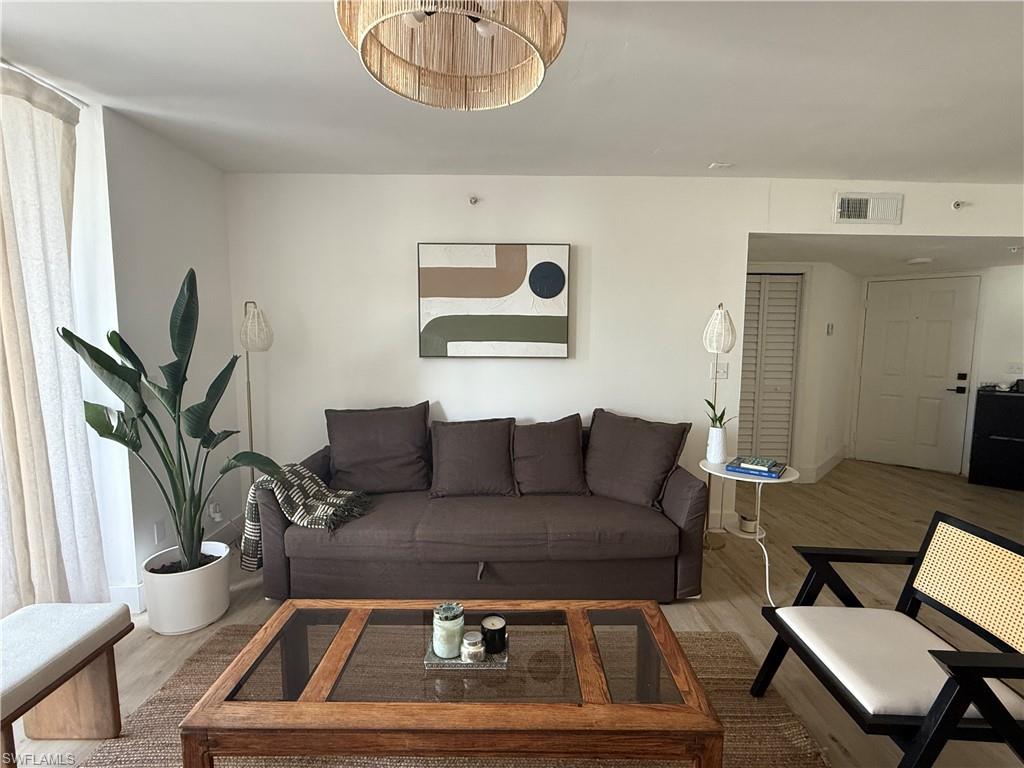 13571 Eagle Ridge Drive, Unit 1325 Fort Myers, FL 33912 - Photo 5 of 17 Living area featuring wood finished floors