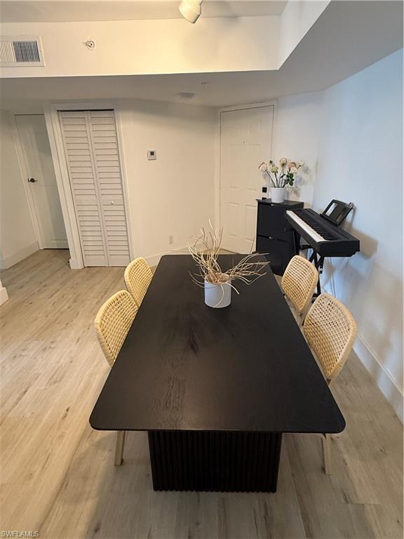 13571 Eagle Ridge Drive, Unit 1325 Fort Myers, FL 33912 - Photo 7 of 17 Dining area with baseboards and light wood-style flooring