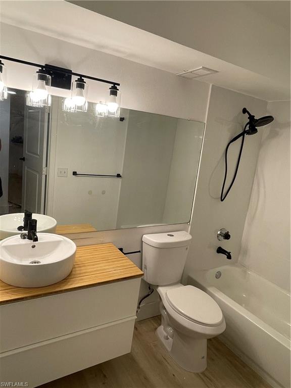 13571 Eagle Ridge Drive, Unit 1325 Fort Myers, FL 33912 - Photo 9 of 17 Full bath with wood finished floors, shower / washtub combination, and vanity