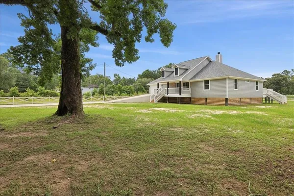 a front view of house with yard and green space