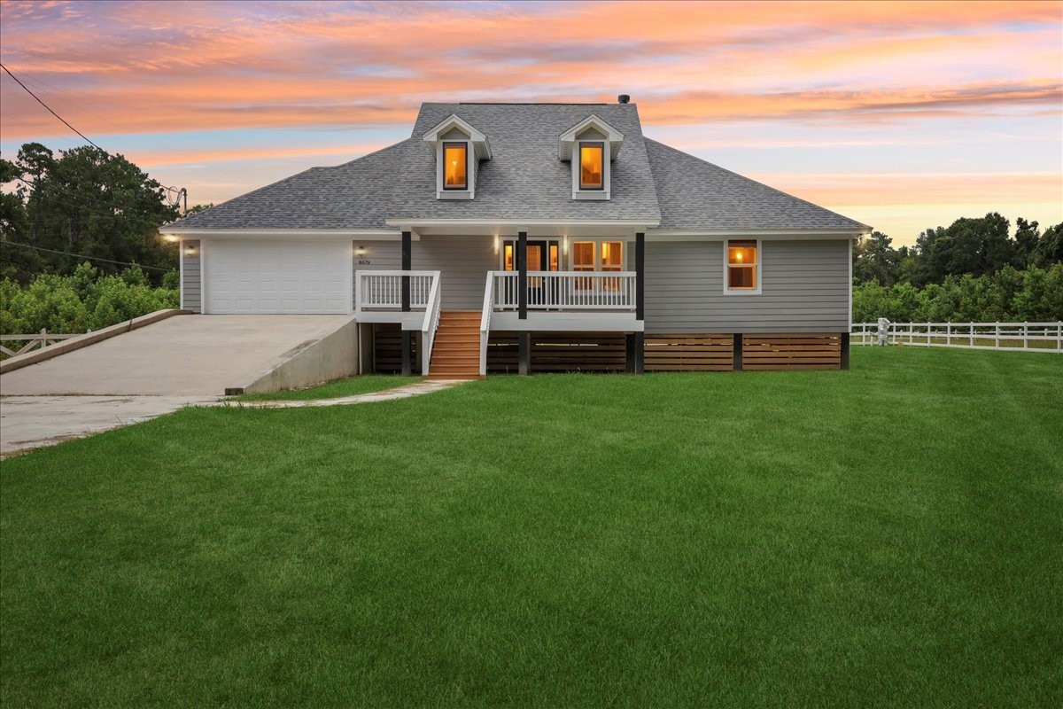a front view of house with yard and green space