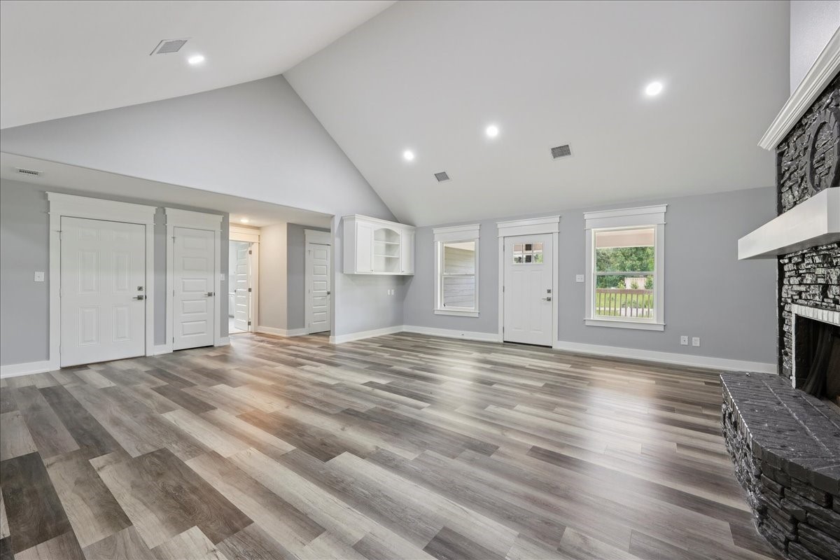 8679 Massey Lake Road Silsbee, TX 77656 - Photo 11 of 37 a view of empty room with wooden floor and fireplace