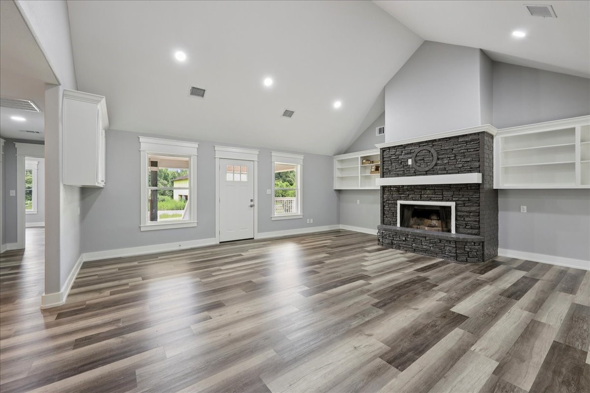 8679 Massey Lake Road Silsbee, TX 77656 - Photo 12 of 37 an empty room with windows and a fireplace