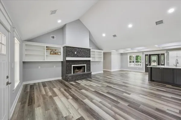 a view of a room with wooden floor and white walls