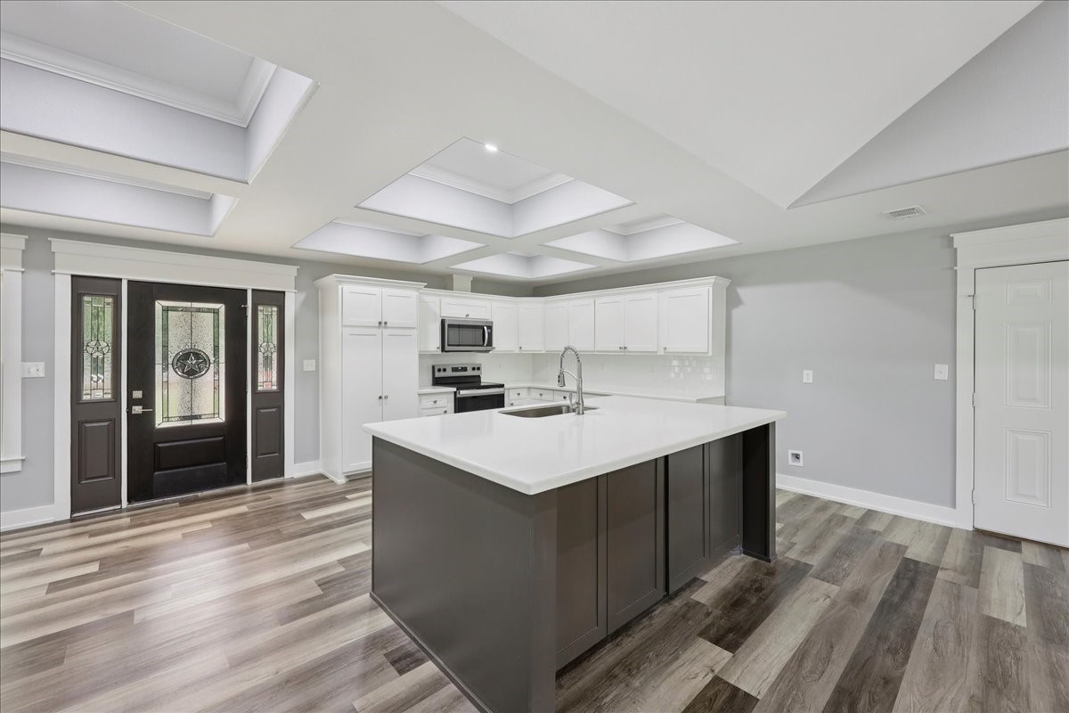 8679 Massey Lake Road Silsbee, TX 77656 - Photo 15 of 37 a kitchen with a sink cabinets and wooden floor