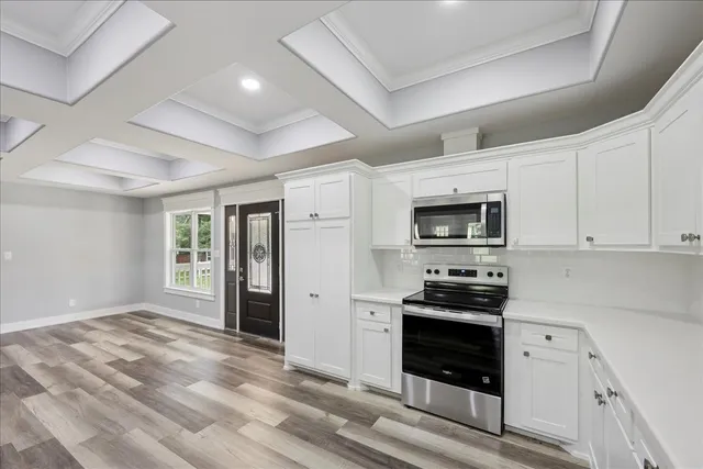 a kitchen with a sink stove and cabinets