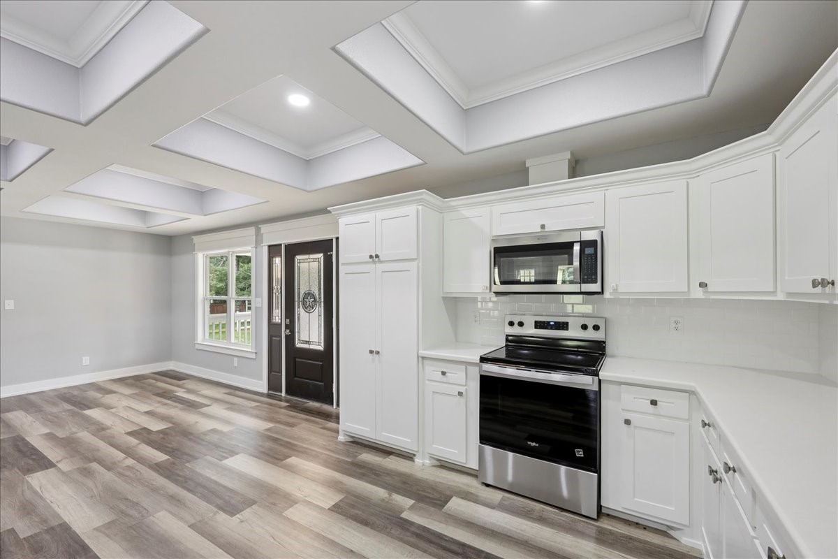 8679 Massey Lake Road Silsbee, TX 77656 - Photo 17 of 37 a kitchen with stainless steel appliances granite countertop a stove and a refrigerator