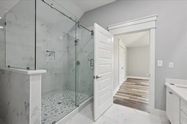a bathroom with a double vanity sink toilet and shower