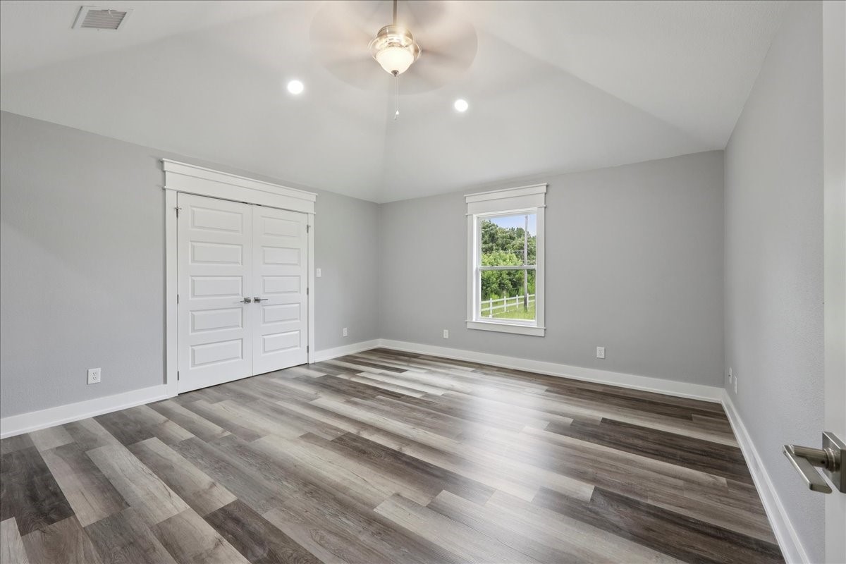 8679 Massey Lake Road Silsbee, TX 77656 - Photo 20 of 37 wooden floor in an empty room with a window
