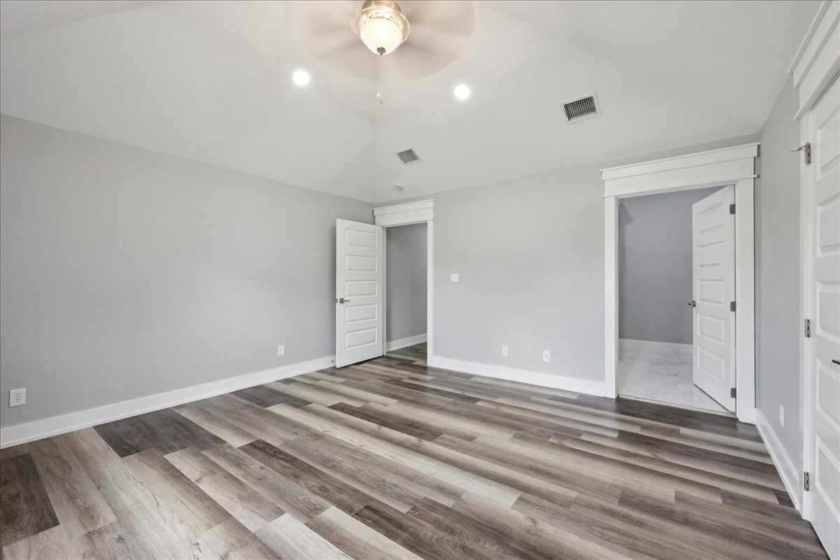 8679 Massey Lake Road Silsbee, TX 77656 - Photo 22 of 37 a view of a room with wooden floor and white walls