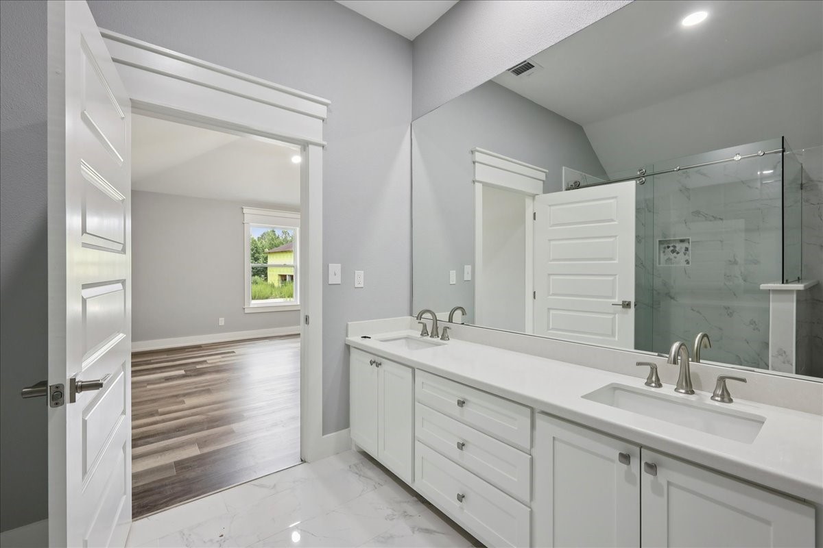 8679 Massey Lake Road Silsbee, TX 77656 - Photo 24 of 37 a bathroom with a double vanity sink and a mirror