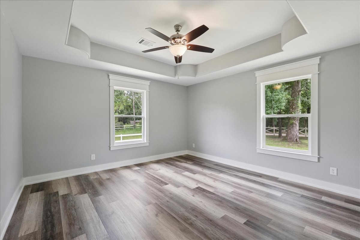 8679 Massey Lake Road Silsbee, TX 77656 - Photo 27 of 37 a view of an empty room with wooden floor and a window