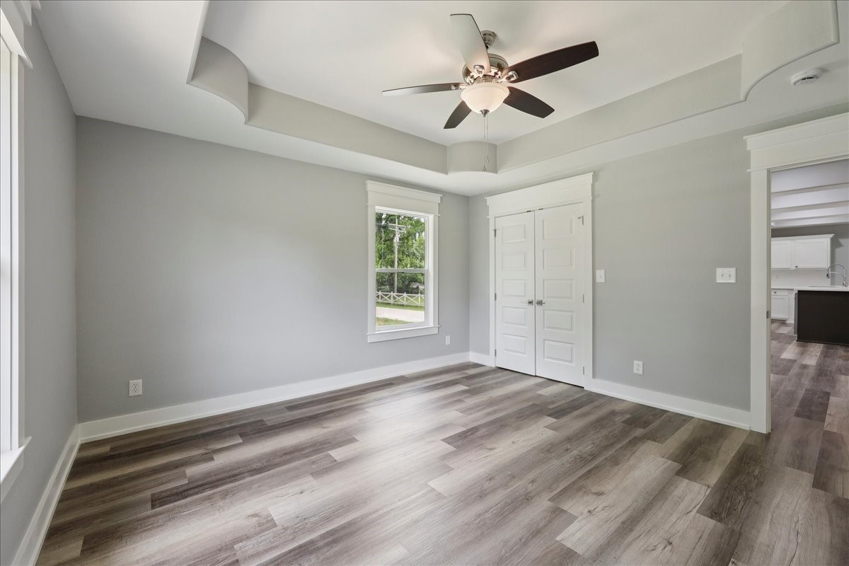 8679 Massey Lake Road Silsbee, TX 77656 - Photo 28 of 37 a view of an empty room with wooden floor and a window