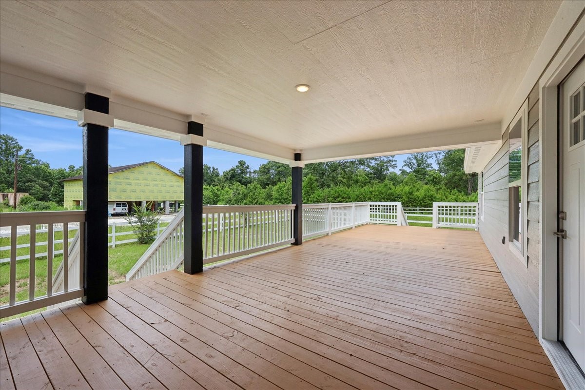 8679 Massey Lake Road Silsbee, TX 77656 - Photo 32 of 37 a view of porch with wooden floor and floor to ceiling window